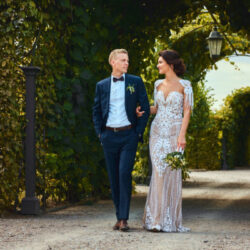 happy wedding couple is walking by the amazing gar WVNJBZ2