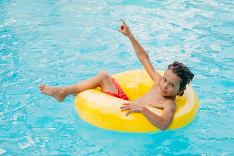 happy holiday time boy having fun in pool with fl 2021 10 06 19 59 43 utc 1