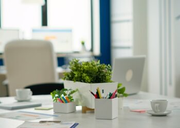 Interior of modern open plan financial office with no people, stylish room interior with meeting table and chairs. Business center with brainstorm area, shot of empty room with modern furniture.